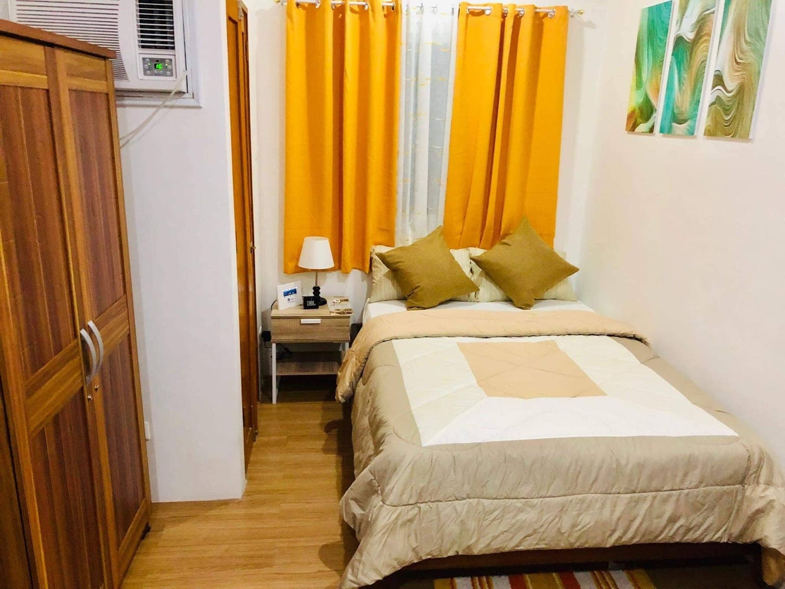 The bedroom from the door, with the window and wardrobe